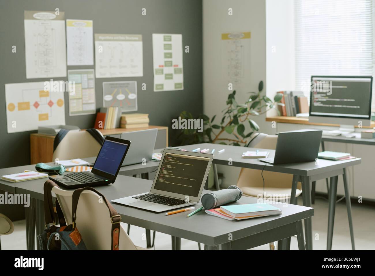 Empty Classroom with Laptops Displaying Code Awaiting Students Arriving Stock Photo