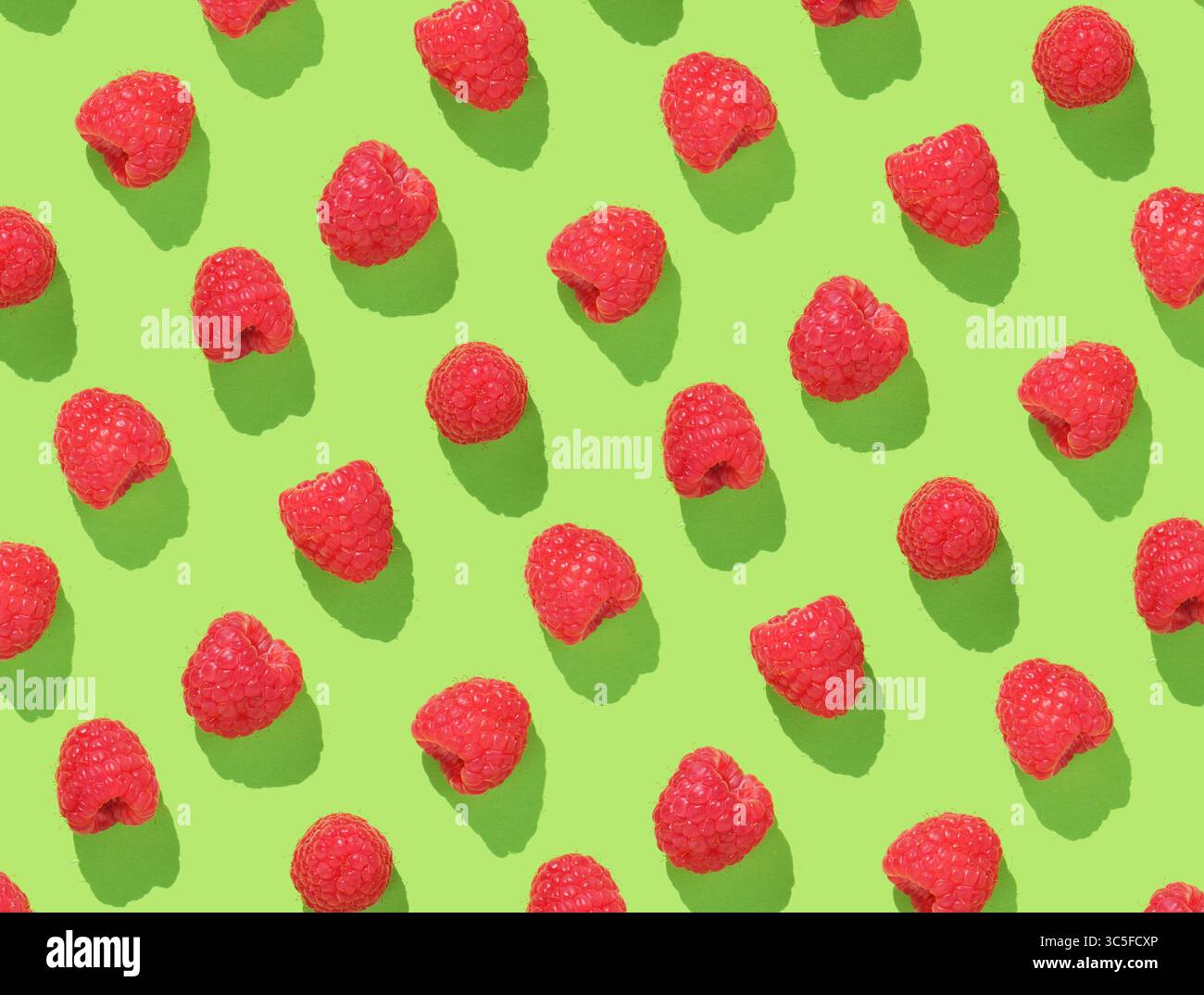 Pattern with raspberries on green background Stock Photo