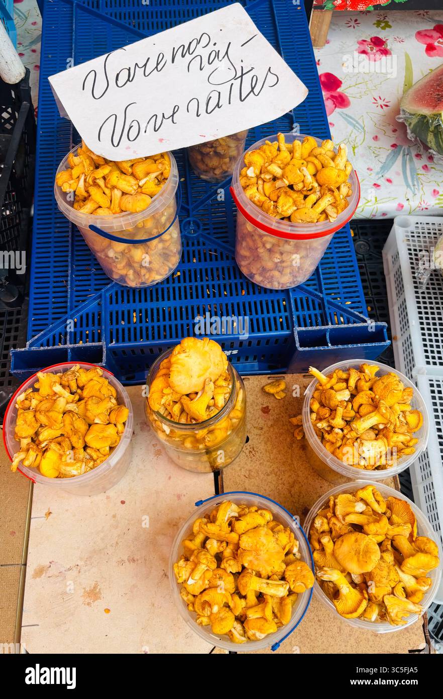 Chanterelle mushrooms displayed by a vendor at the Halės Turgus market in Vilnius, Lithuania. - Smartphone Captured Stock Image