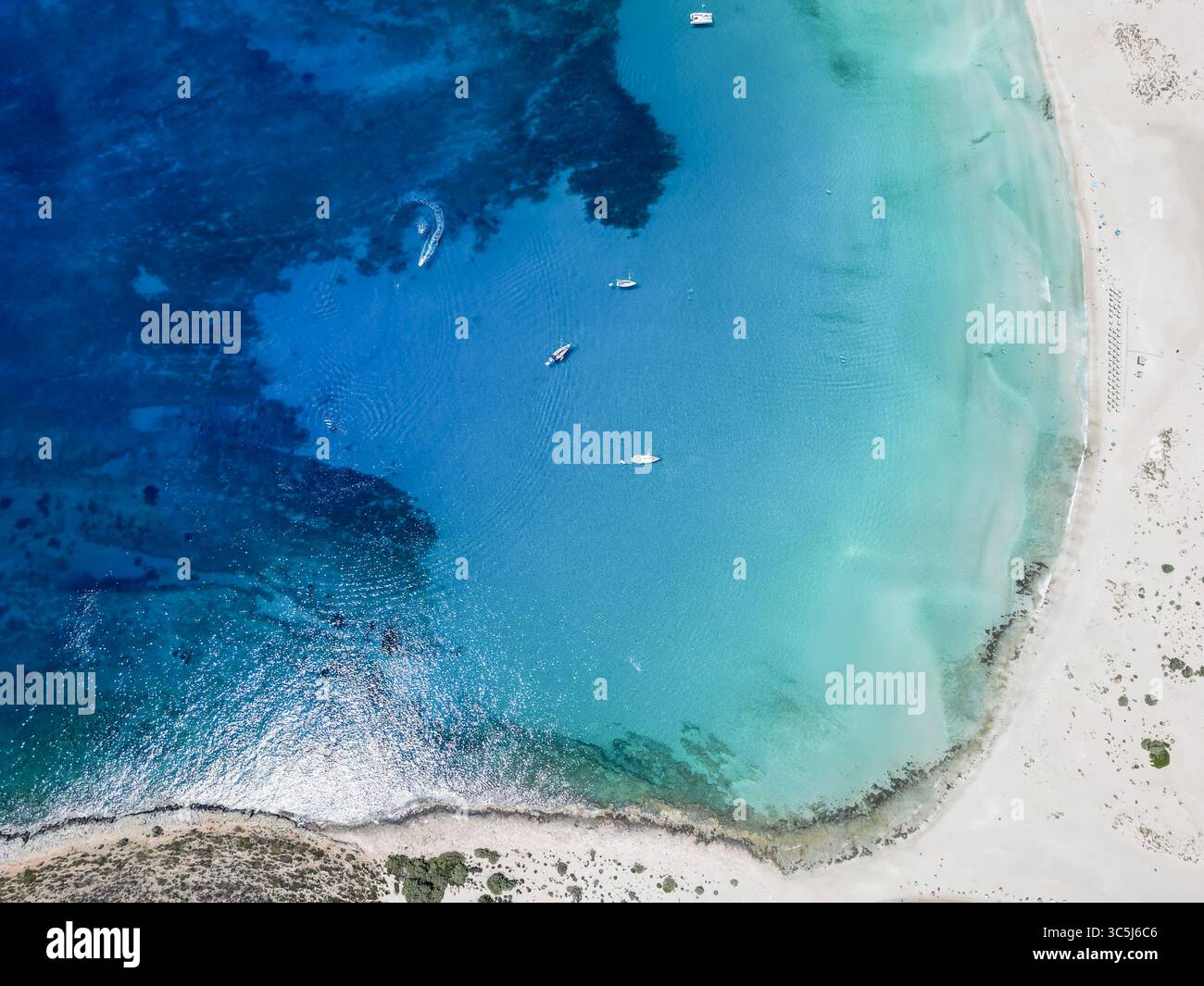 Aerial view of the turquoise sea meeting the white sandy beach, a ...