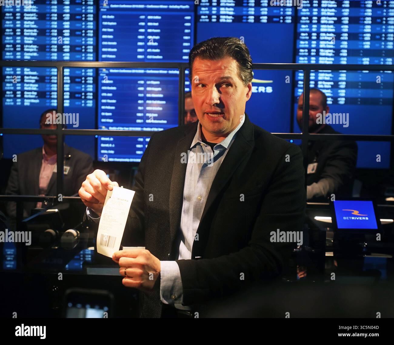 March 9, 2020, Des Plaines, Illinois, USA: Monday, March 9, 2020 - Des Plaines, Illinois, U.S. -  Former Chicago Blackhawks star EDDIE OLCYZK makes Illinois' first sportsbook wager and puts $100 down on his hometown White Sox to win the American League pennant at 16-to-1 odds at BetRivers Sportsbook in Rivers Casino in Des Plaines, Illinois. Sports gambling was legalized in 2019 when Illinois lawmakers approved the gambling expansion bill, which included new casinos, sports betting. Illinois projects to raise between $58 to $102 million a year in annual state tax revenues from sports gambling. Stock Photo