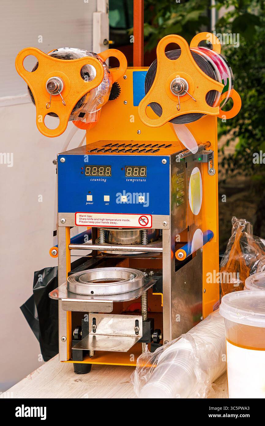 Modern label maker machine technology in a factory Stock Photo - Alamy