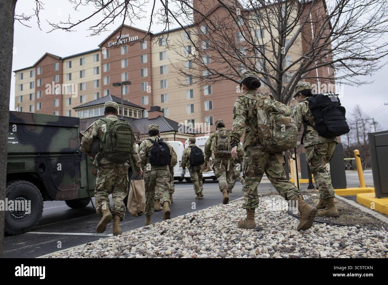 March 26, 2020, IL, USA: Members of Illinois National Guard walk back to their hotel from their convoy parking in the Rivers Casino parking lot after completing a day of coronavirus testing Thursday, March 26, 2020. (Credit Image: © TNS via ZUMA Wire) Stock Photo