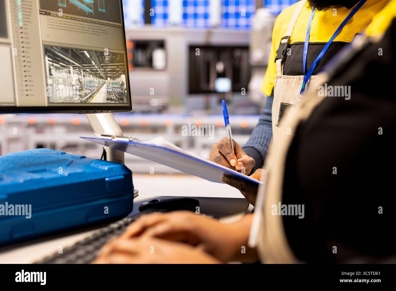 Industry 4.0 engineers designs robotic machinery using CAD software on ...