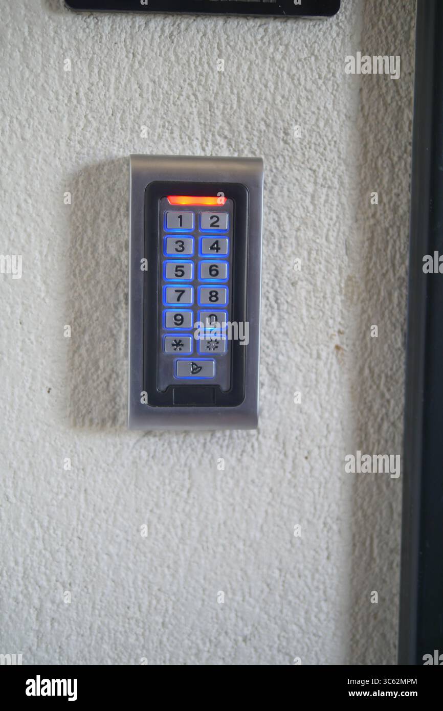 Keypad entry device mounted on a wall for secure access Stock Photo