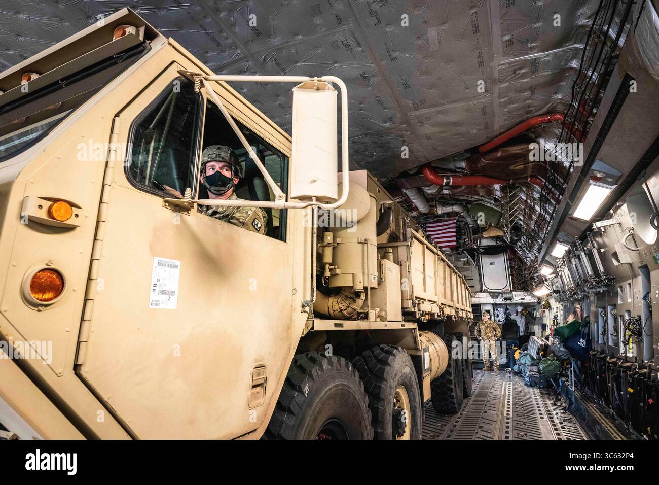 May 11, 2020 - Lawton, Oklahoma, USA - A member of the rear detachment of 3rd Battalion, 2nd Air Defense Artillery Regiment, 31st Air Defense Artillery Brigade, drives an electric power plant onto an aircraft during strategic air load operations in Lawton, Okla., May 11, 2020.  All soldiers were required to wear face masks in accordance with COVID-19 guidance. (Credit Image: © U.S. /ZUMA Wire/ZUMAPRESS.com) Stock Photo