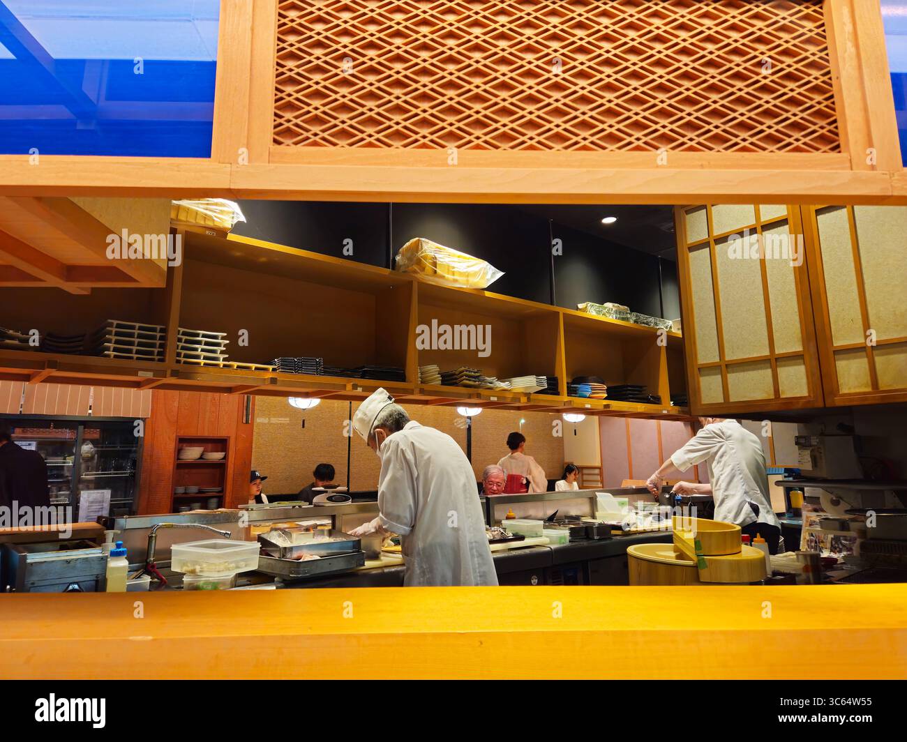 Sushi Chefs Preparing Dishes Behind Counter in Osaka Restaurant, Japan ...