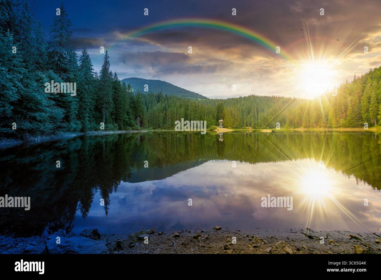 remote mountain landscape with forest lake on summer solstice. travel nature background with sun and moon. scenic view of coniferous trees reflection Stock Photo