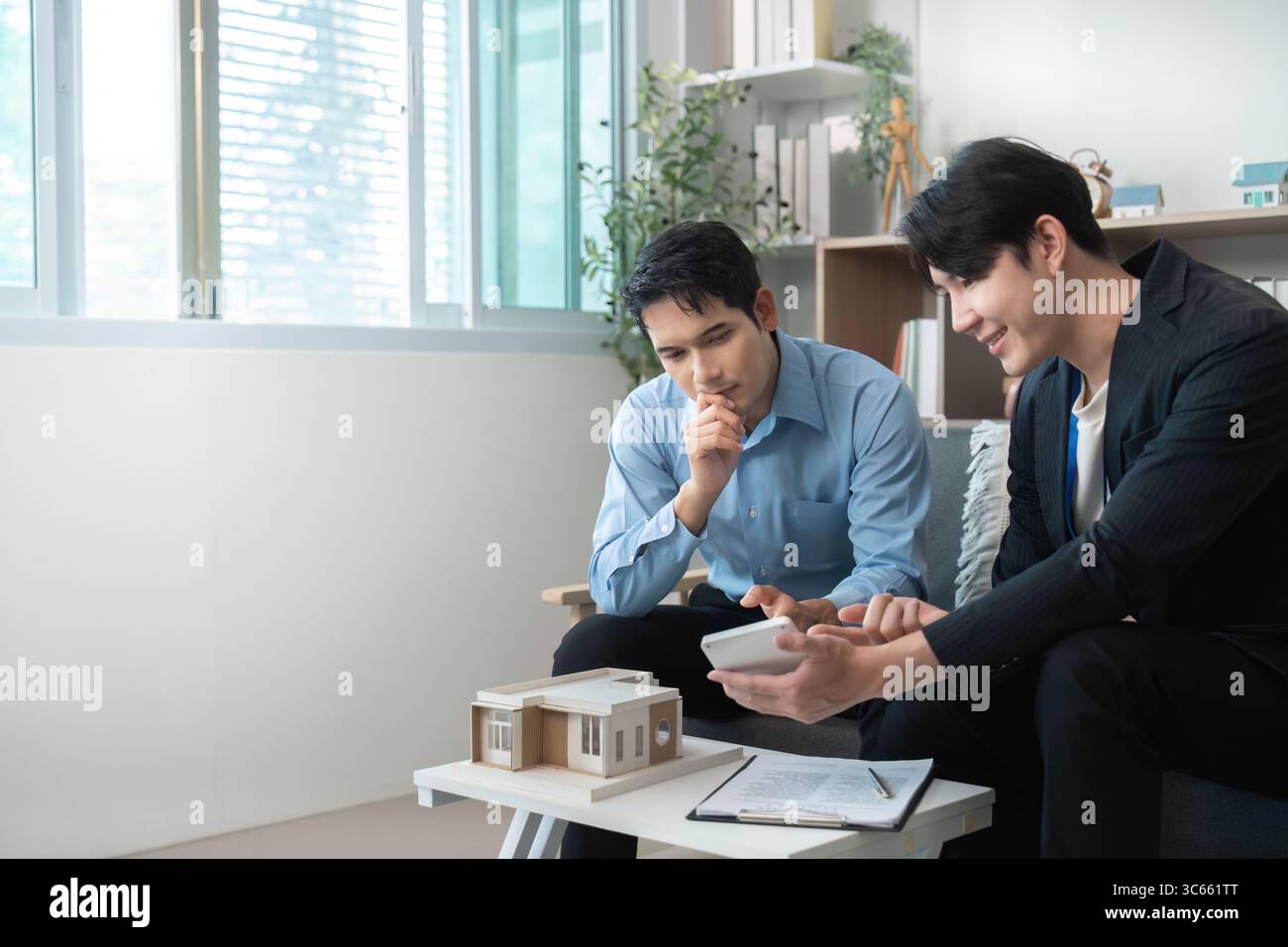 Creative Collaboration. Architects discussing building model and project ideas. Stock Photo