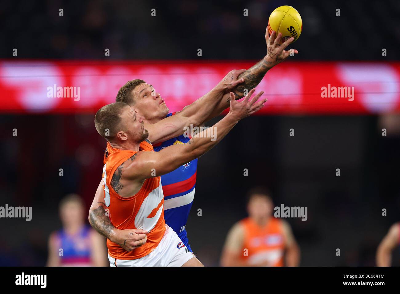 Jake Stringer of the Giants and Rory Lobb of the Bulldogs compete for ...