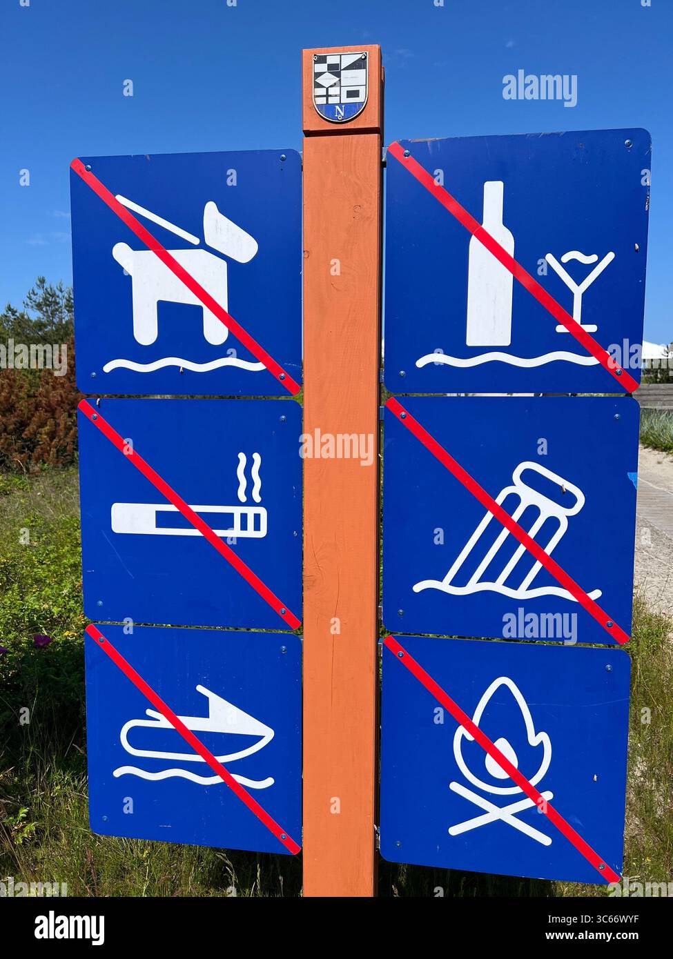 Beach warning sign in Preila, Lithuania, listing prohibited activities: no dogs, alcohol, smoking, littering, fires or diving. Summer safety and rules - Smartphone Captured Stock Image