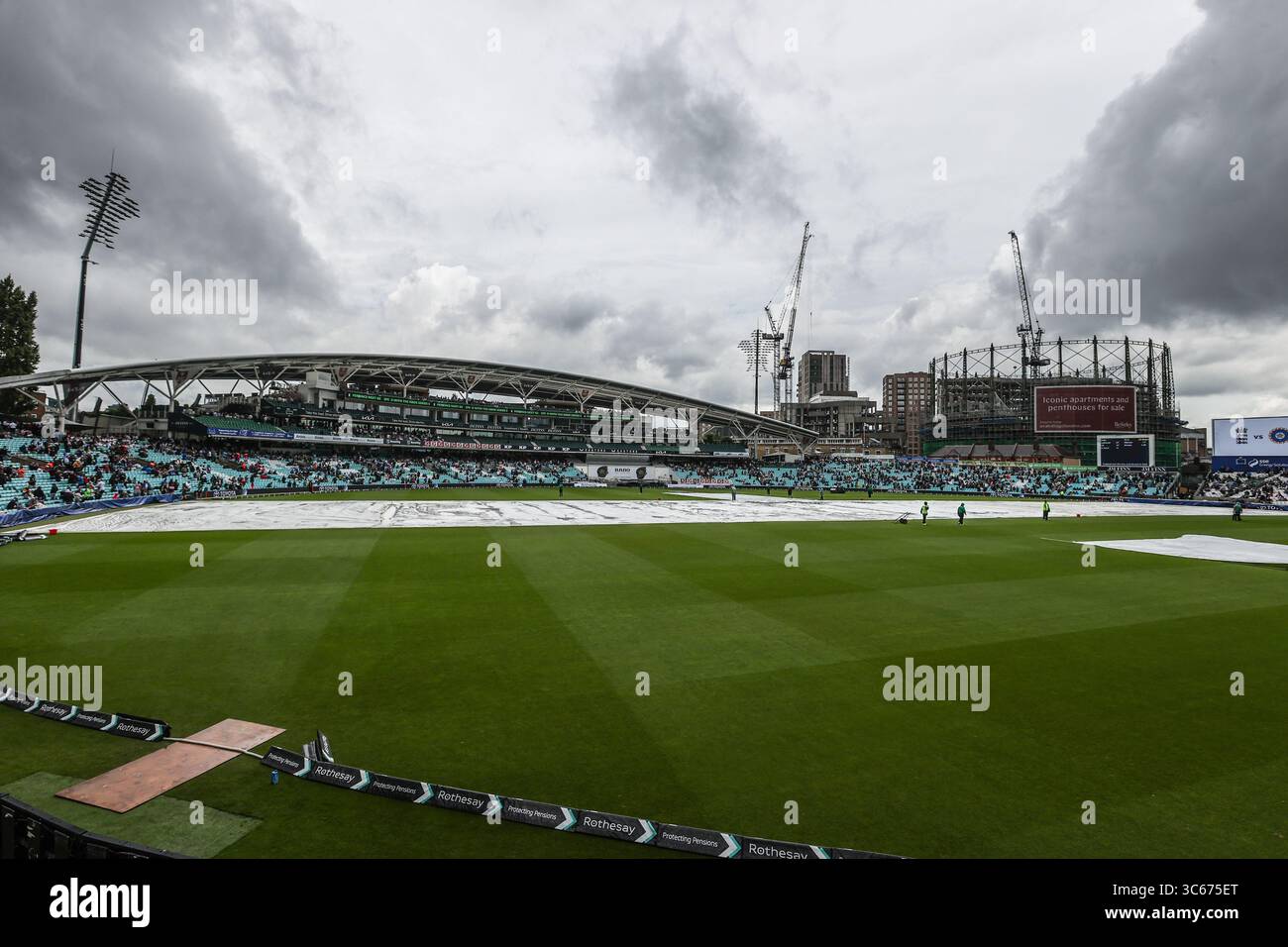 The Covers Are Brought Onto The Pitch As Heavy Rain Hits The Oval the-covers-are-brought-onto-the-pitch-as-heavy-rain-hits-the-oval