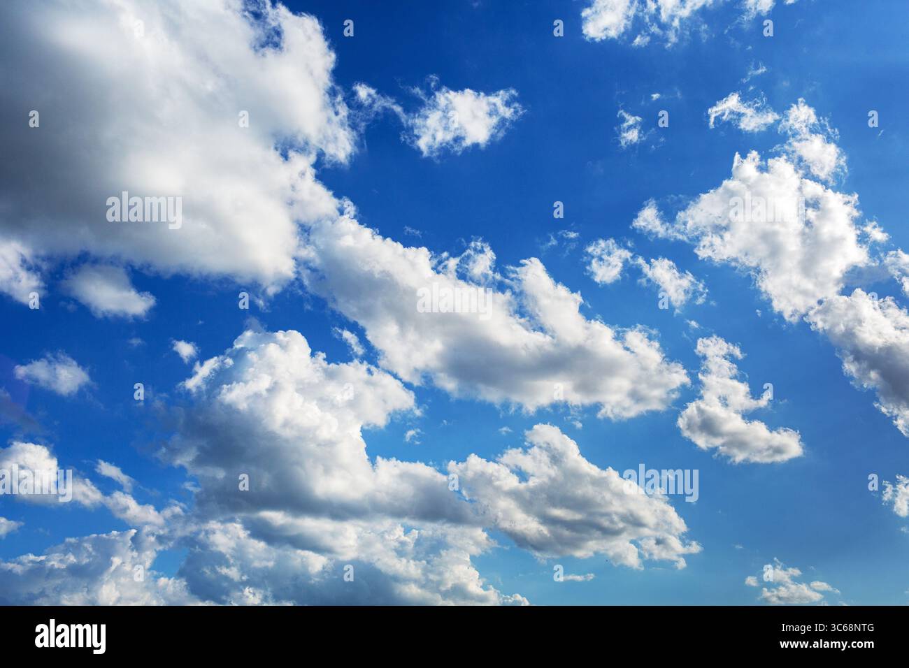 White fluffy serene clouds float across the sky giving a feeling of calm and solitude Stock Photo