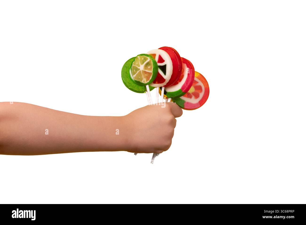 Child’s hand holding colorful fruit lollipops, isolated on white background for clean and versatile design use. Stock Photo
