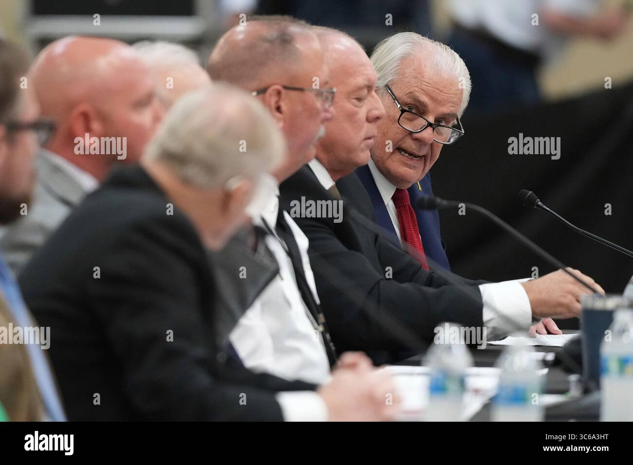 Kerr County Judge Rob Kelly, right, testifies during a Senate and House