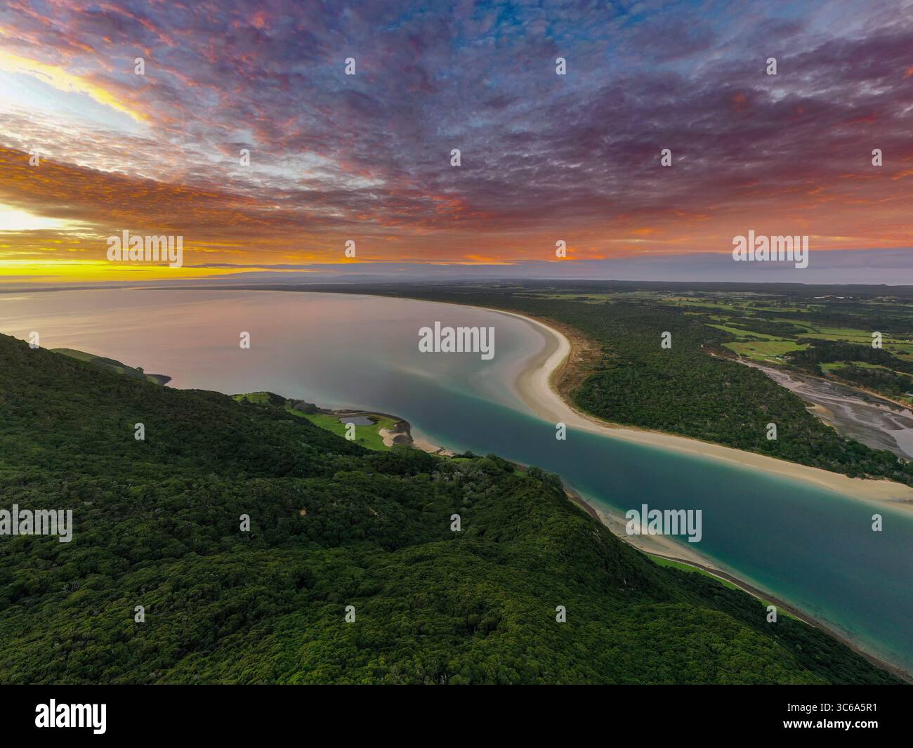 Aerial view of the tranquil river mouth meeting the vast ocean under a ...