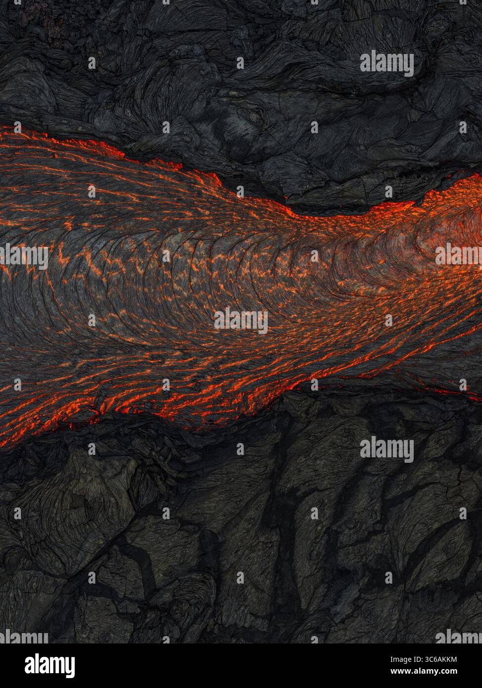 Aerial view of molten lava flowing through jagged, dark volcanic rock ...