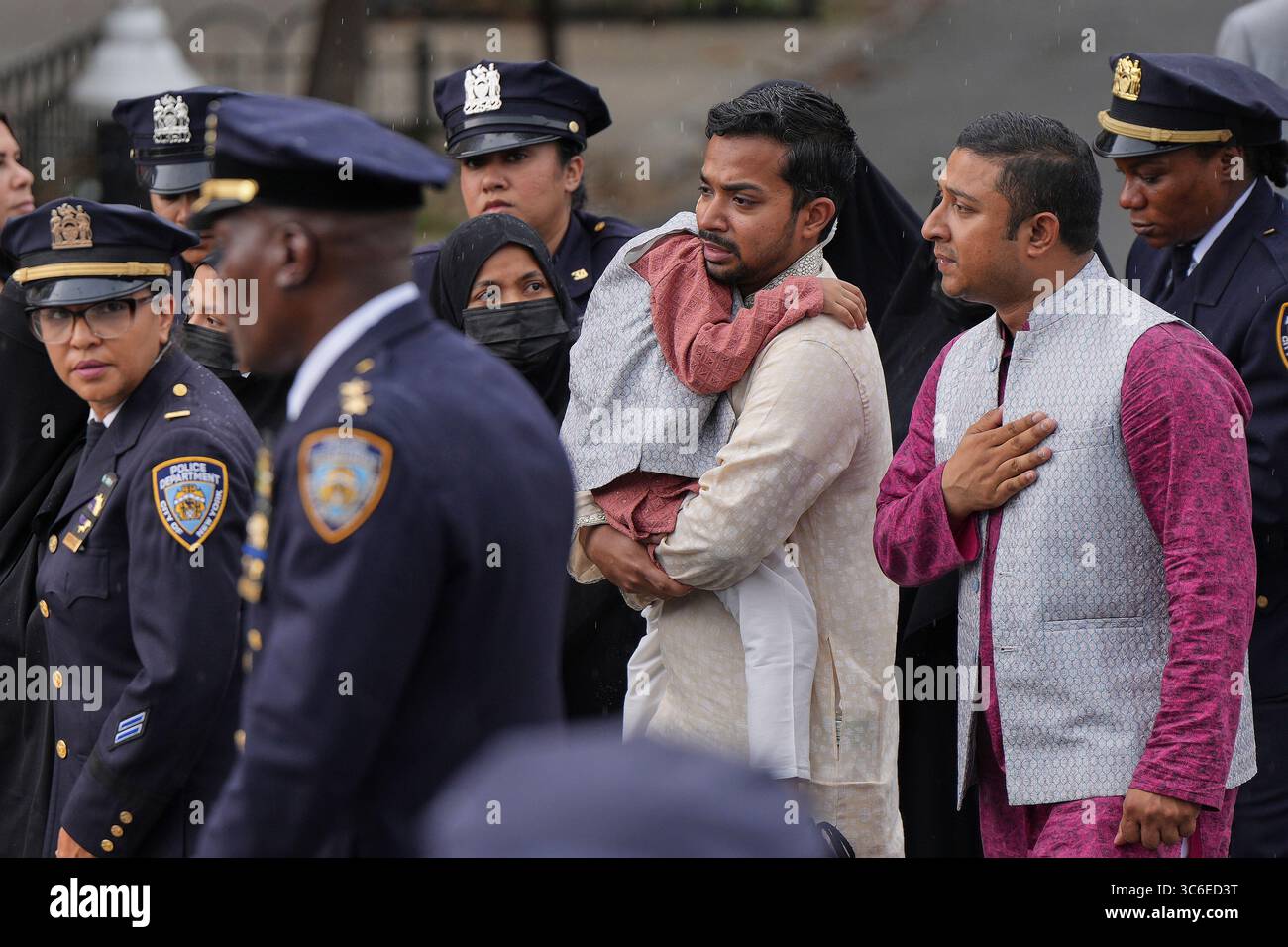 Family members of NYPD officer Didarul Islam walk in a procession after ...