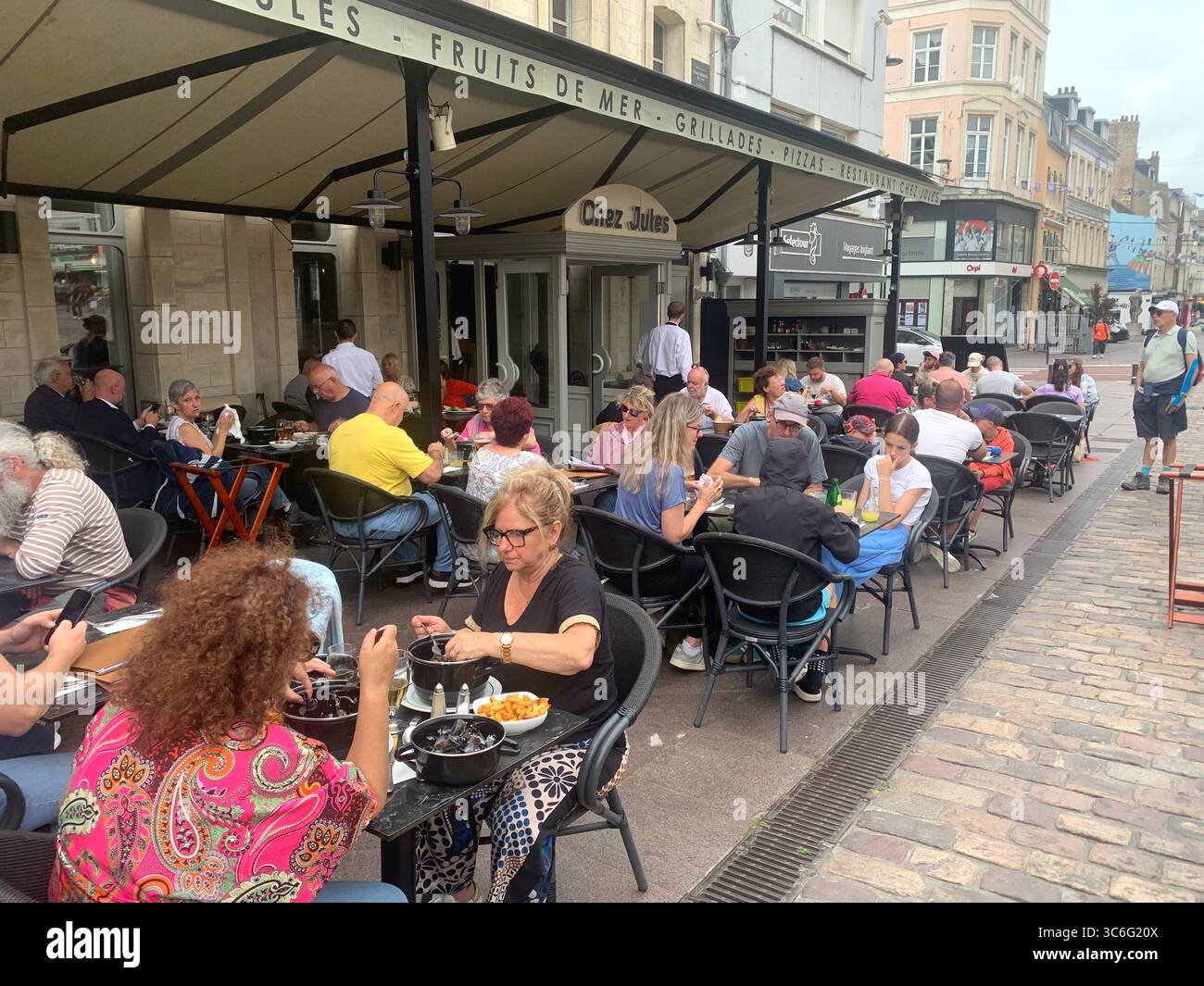 Boulogne Sur Mer France shop shops restaurant Restaurants Town place living street home Church eating outside out warm Sunny food place muscles - Smartphone Captured Stock Image
