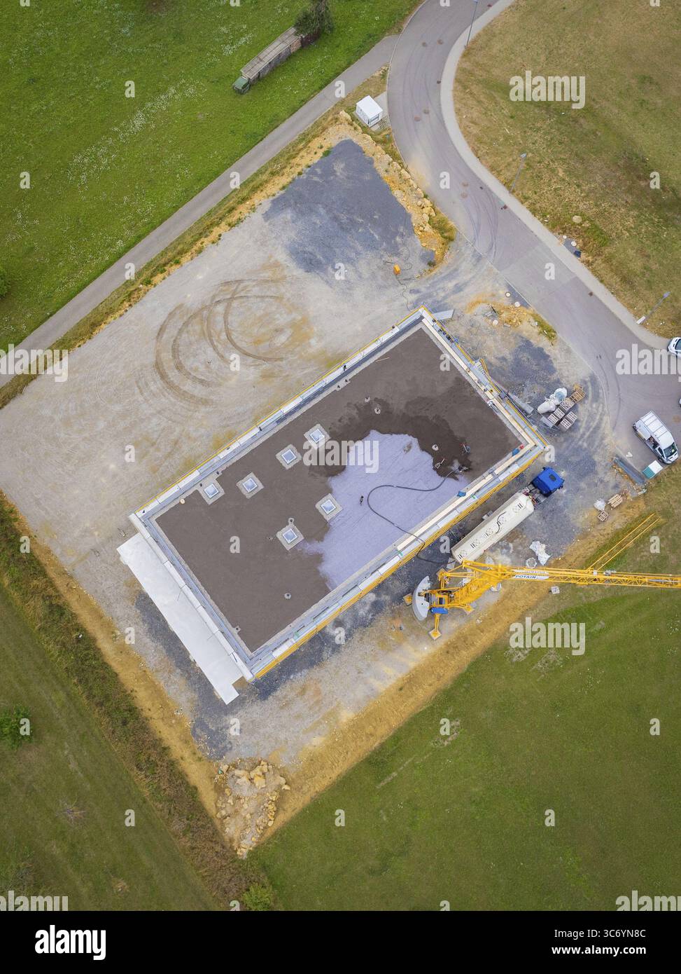 Aerial view of a rectangular building in shell construction on a large ...