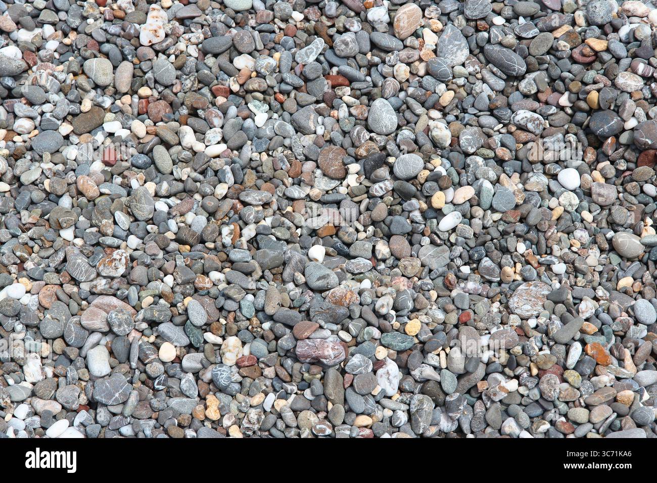 Pebbly beach background from Crete, Greece. Shingle beach. Stock Photo