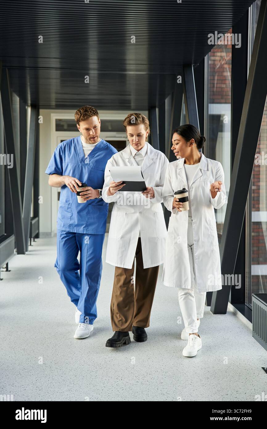 Three multicultural doctors share insights while working together in a ...