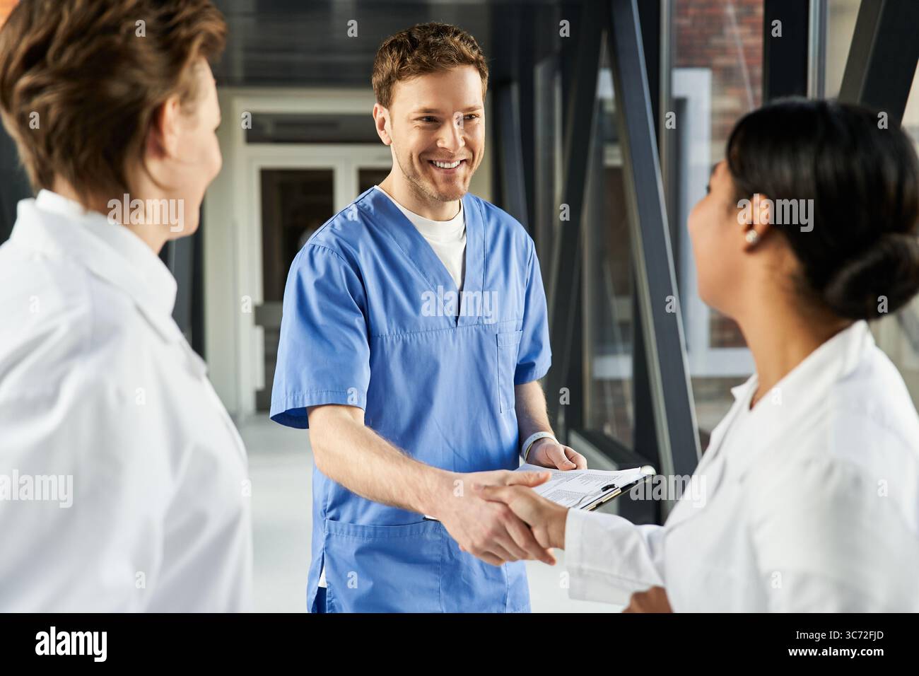 Three doctors collaborate in a modern hospital, sharing knowledge and ...