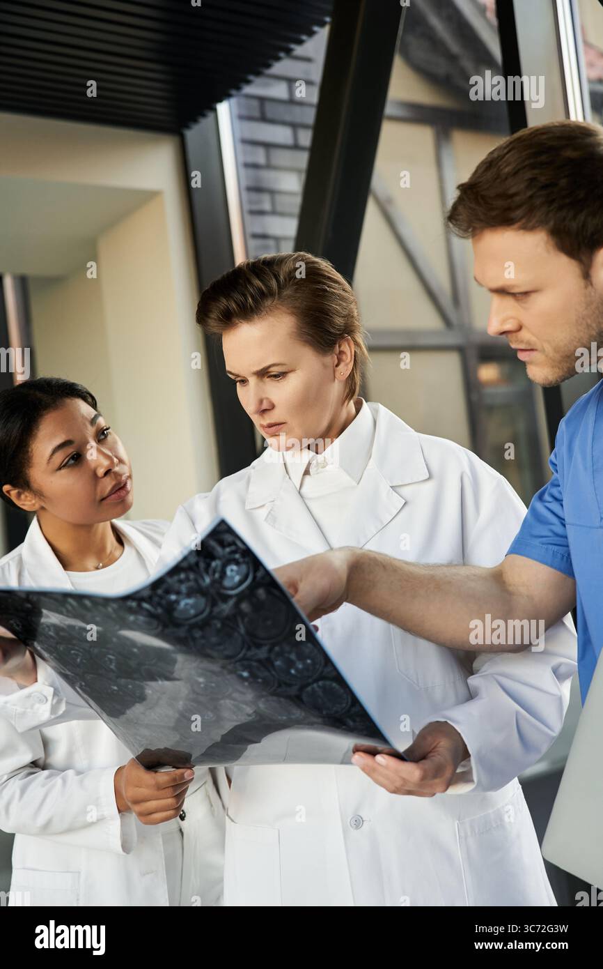 Three multicultural doctors examine a medical report in a contemporary ...