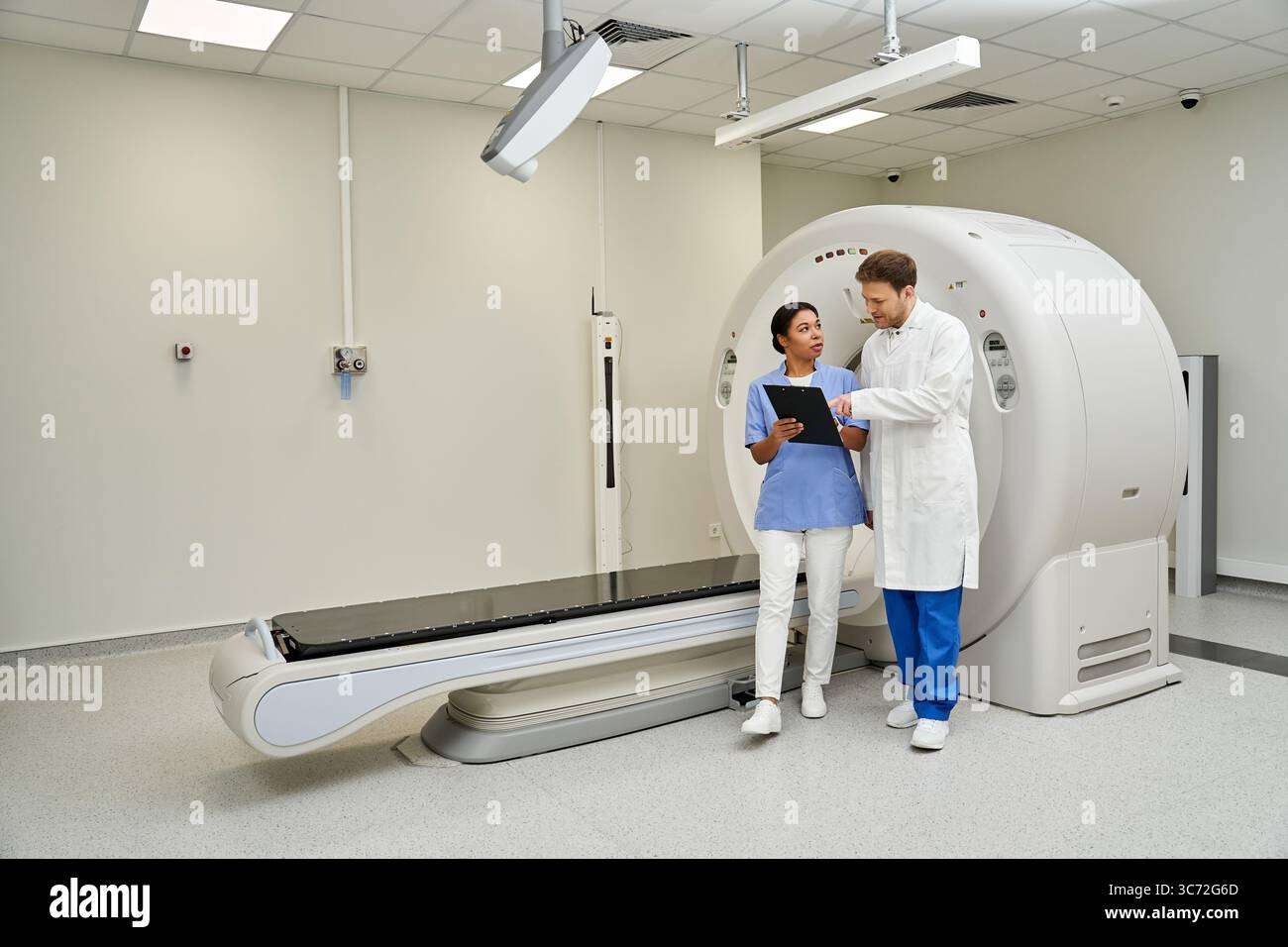 Doctor Using Mri Two doctors discuss an MRI scan in a modern hospital, reflecting ...