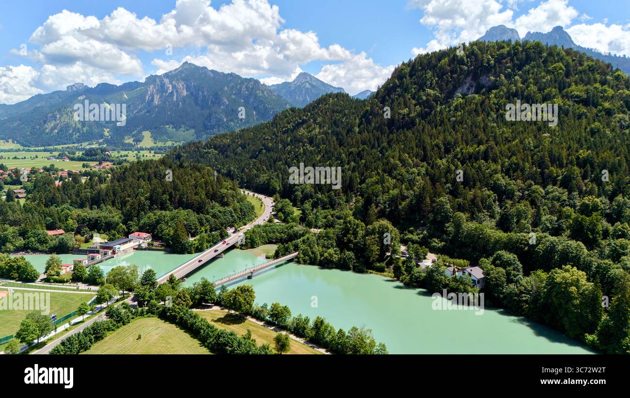 Aerial view of river winding through lush green hills and mountains ...