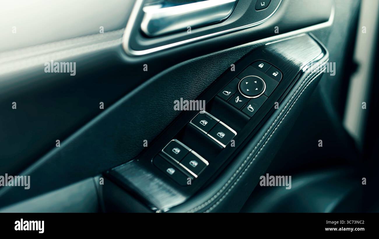 Detailed close-up of a car door control panel with window and lock ...