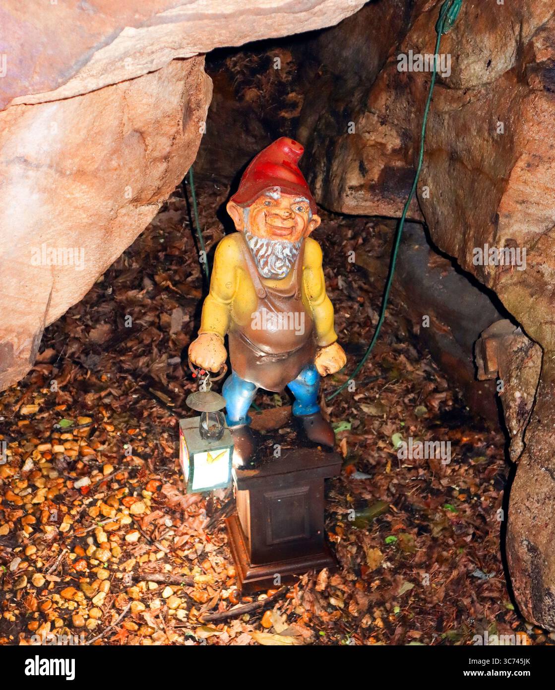 A whimsical gnome statue greets visitors at Rock City, Georgia—part of the attraction’s charming fairy-tale trail. Stock Photo