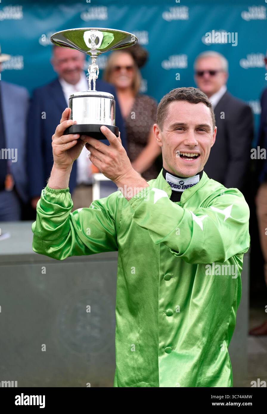 Jockey Jason Hart celebrates with the trophy after winning the King ...