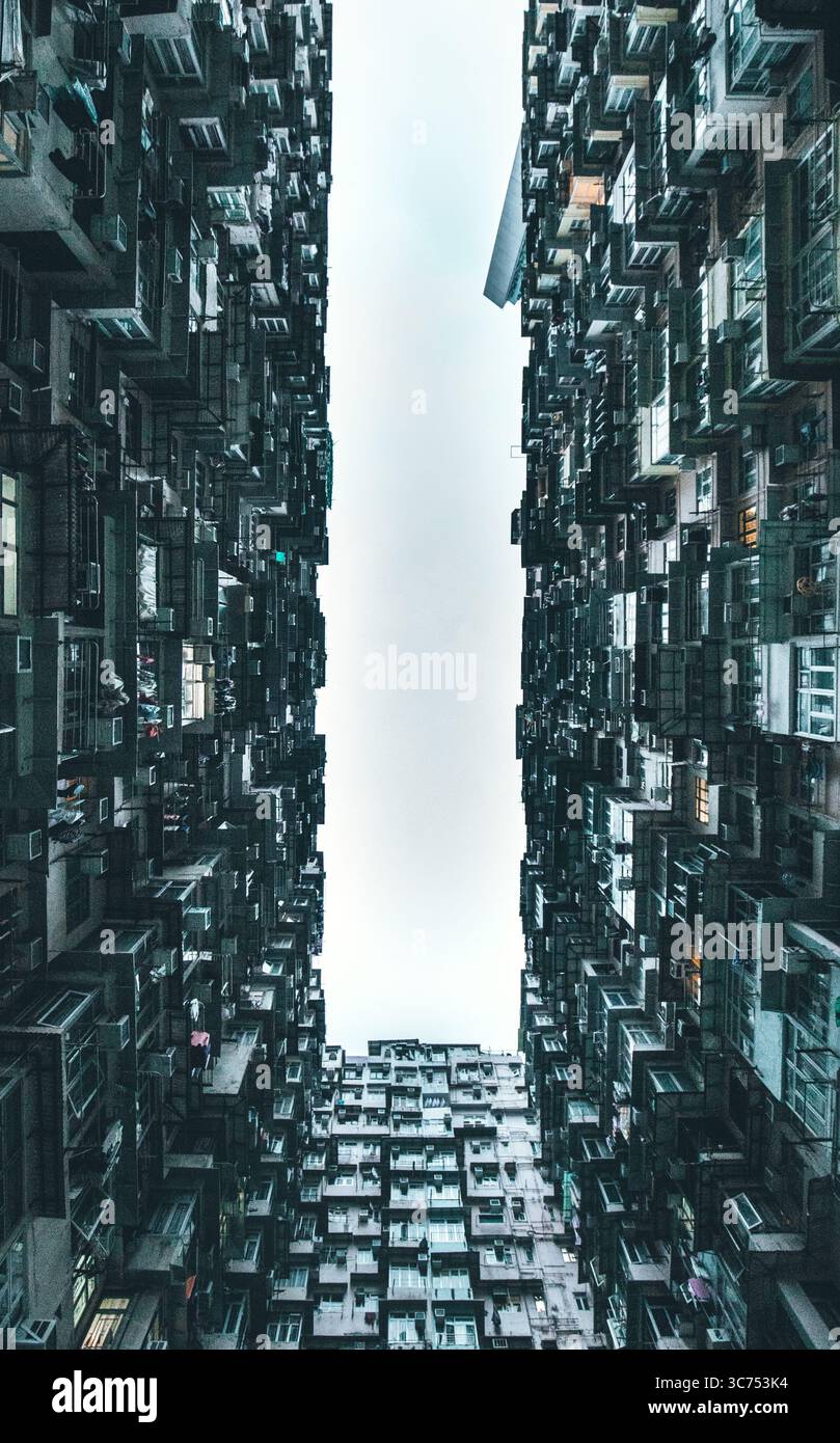 Dense cluster of high-rise residential buildings at 山海樓, a famous urban photography spot in Hong Kong known for its striking architectural patterns. Stock Photo