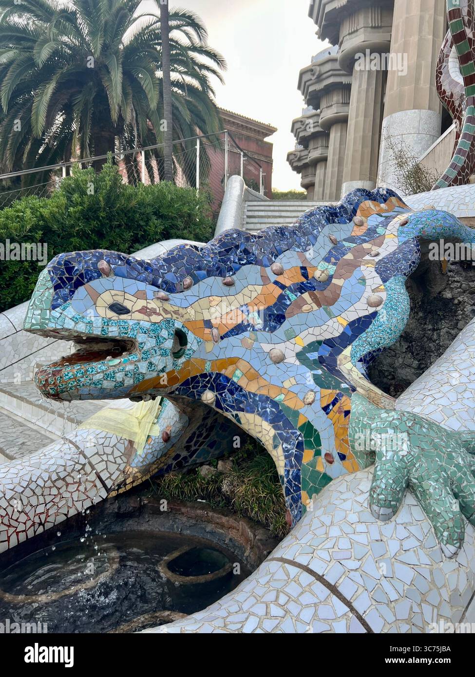 The famous mosaic salamander known as “El Drac” at the entrance of Park Güell, designed by Antoni Gaudí, Barcelona, Catalonia, Spain. - Smartphone Captured Stock Image