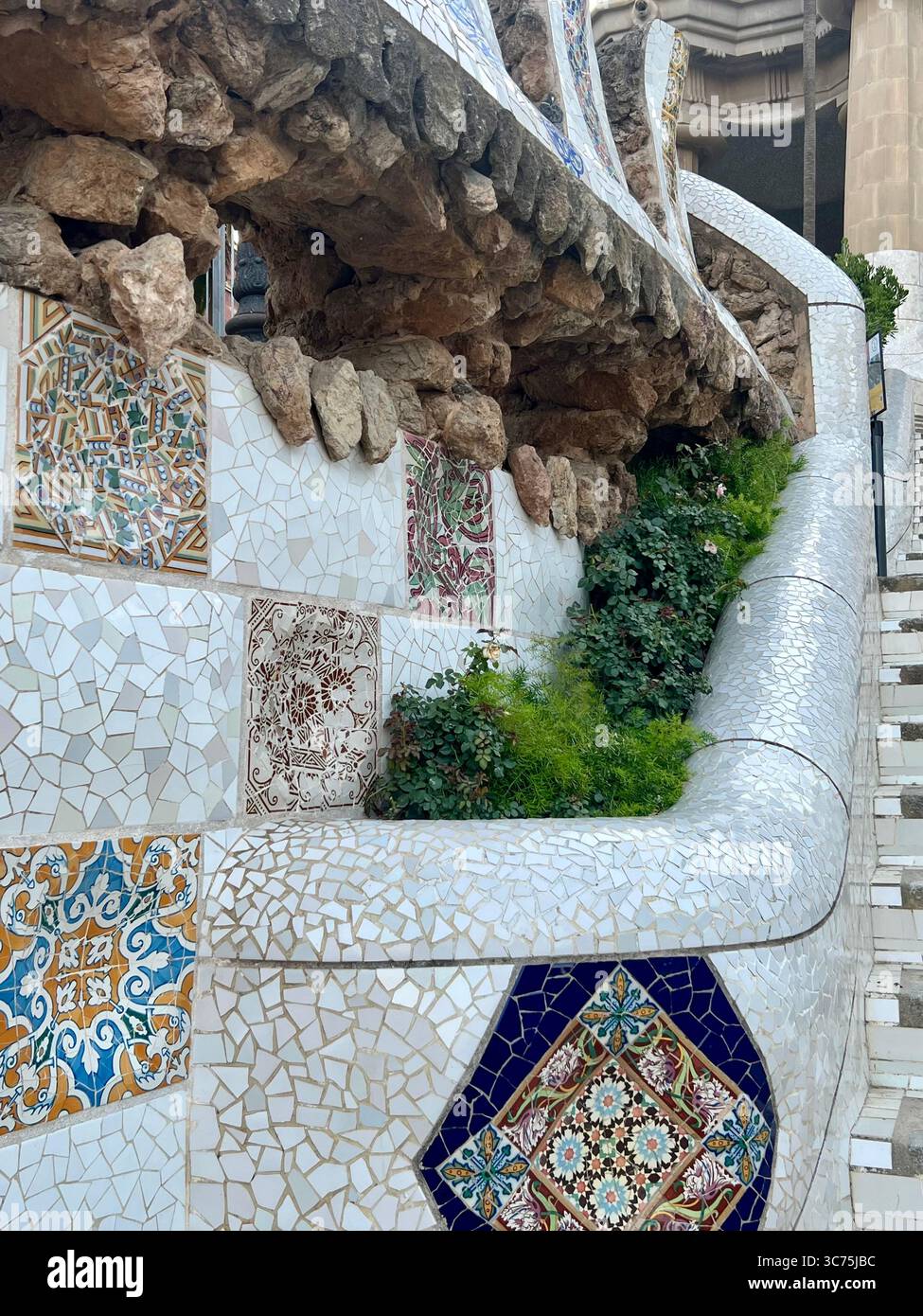 Close-up of colorful mosaic tiles designed by Antoni Gaudí at the entrance of Park Güell, Barcelona, Catalonia, Spain. - Smartphone Captured Stock Image