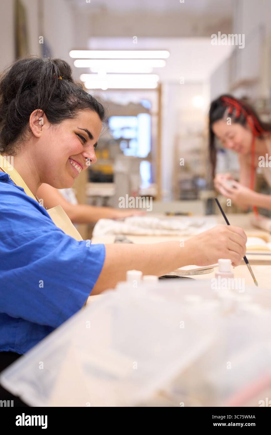 Female artist painting ceramics in a small business workshop Stock ...