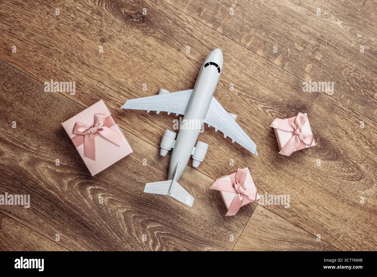 Air delivery. Plane figurine and gift boxes on floor. Flat lay. Top view Stock Photo