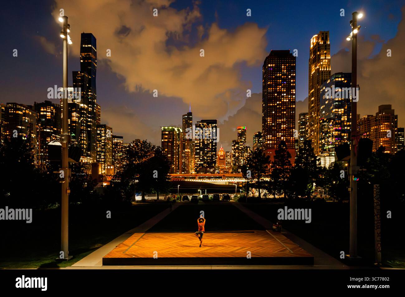 Chicago Yoga Night Tree Pose is practiced with the Aqua Tower built in 2009, Trump International Hotel and Tower completed in 2009, and St. Regis Chic Stock Photo