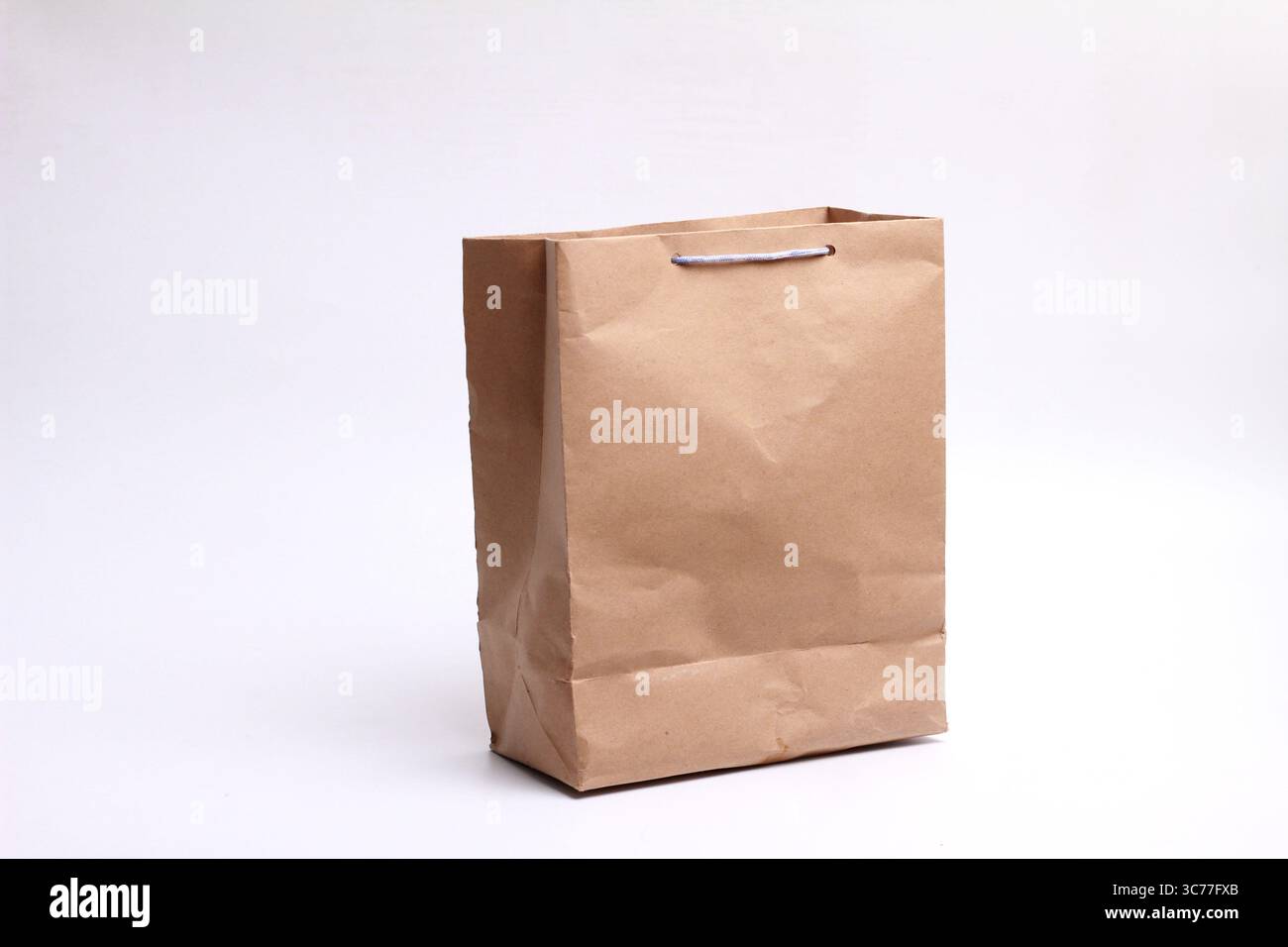 Brown paper bag isolated on white background. Stock Photo