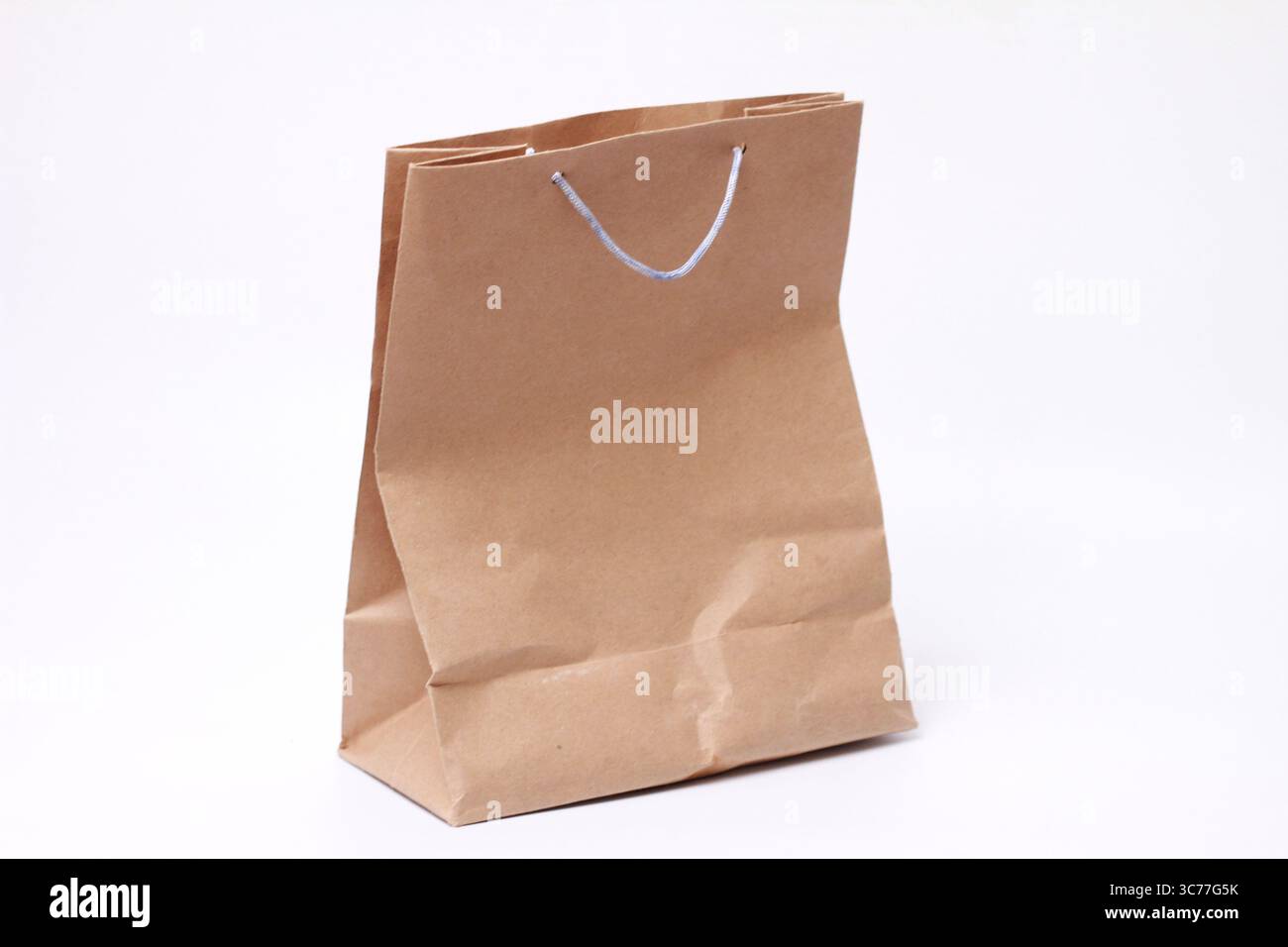 Brown paper bag isolated on white background. Stock Photo