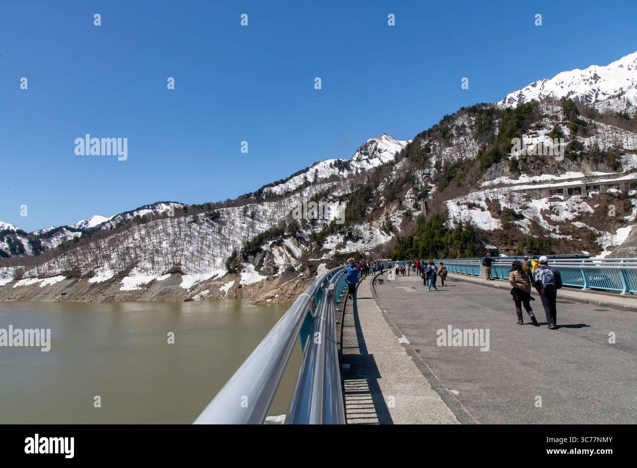 Tateyama, Japan - April 24, 2025: The Kurobe Dam on the snow-covered Tateyama Kurobe Alpine Route in the Tateyama Mountain Range Northern Japan Alps, Stock Photo