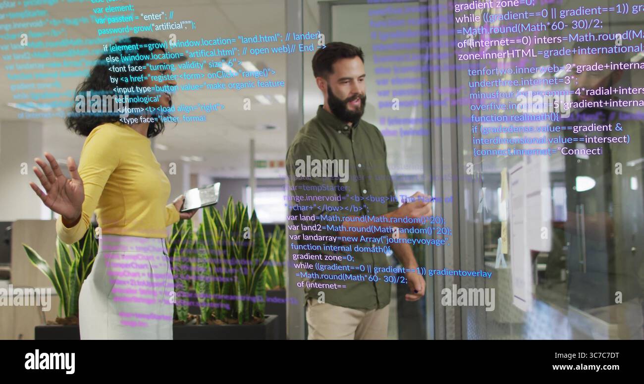 Two software engineers analyzing code on glass wall in office, using tablet stylus and monitors Stock Photo