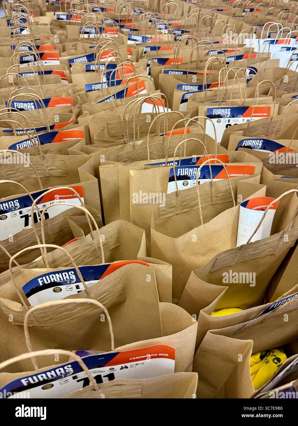Kit bags with participant bib numbers prepared for the Furnas Night Trail running event in the Azores islands, Portugal. - Smartphone Captured Stock Image