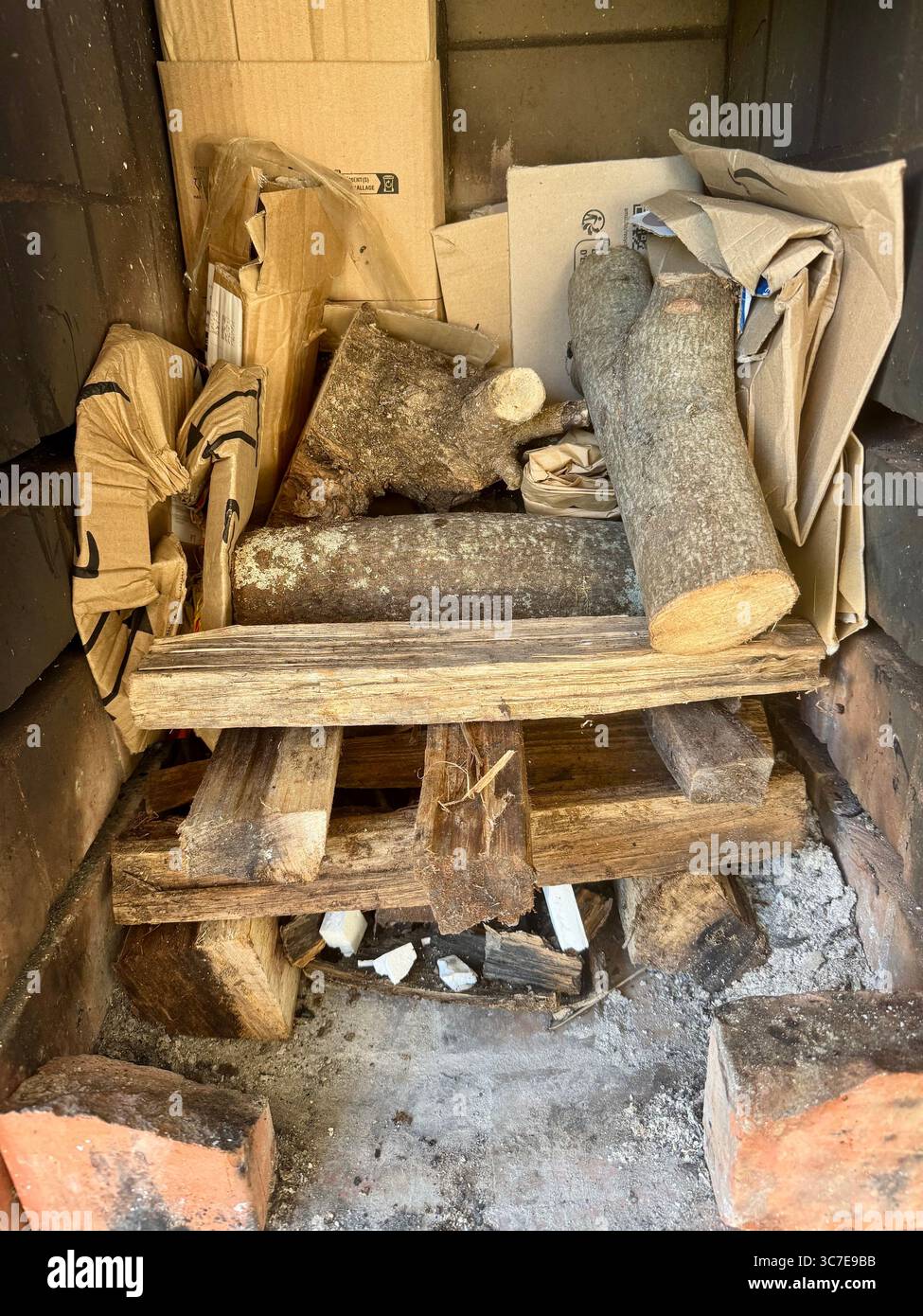 Stack of wood logs and kindling prepared for a barbecue fire. - Smartphone Captured Stock Image
