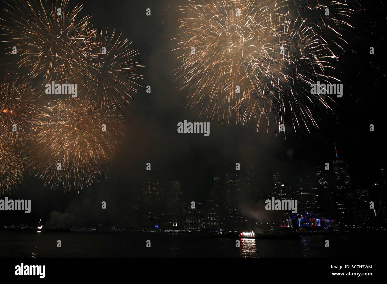 Fourth of July fireworks launched from barges on the East River are ...