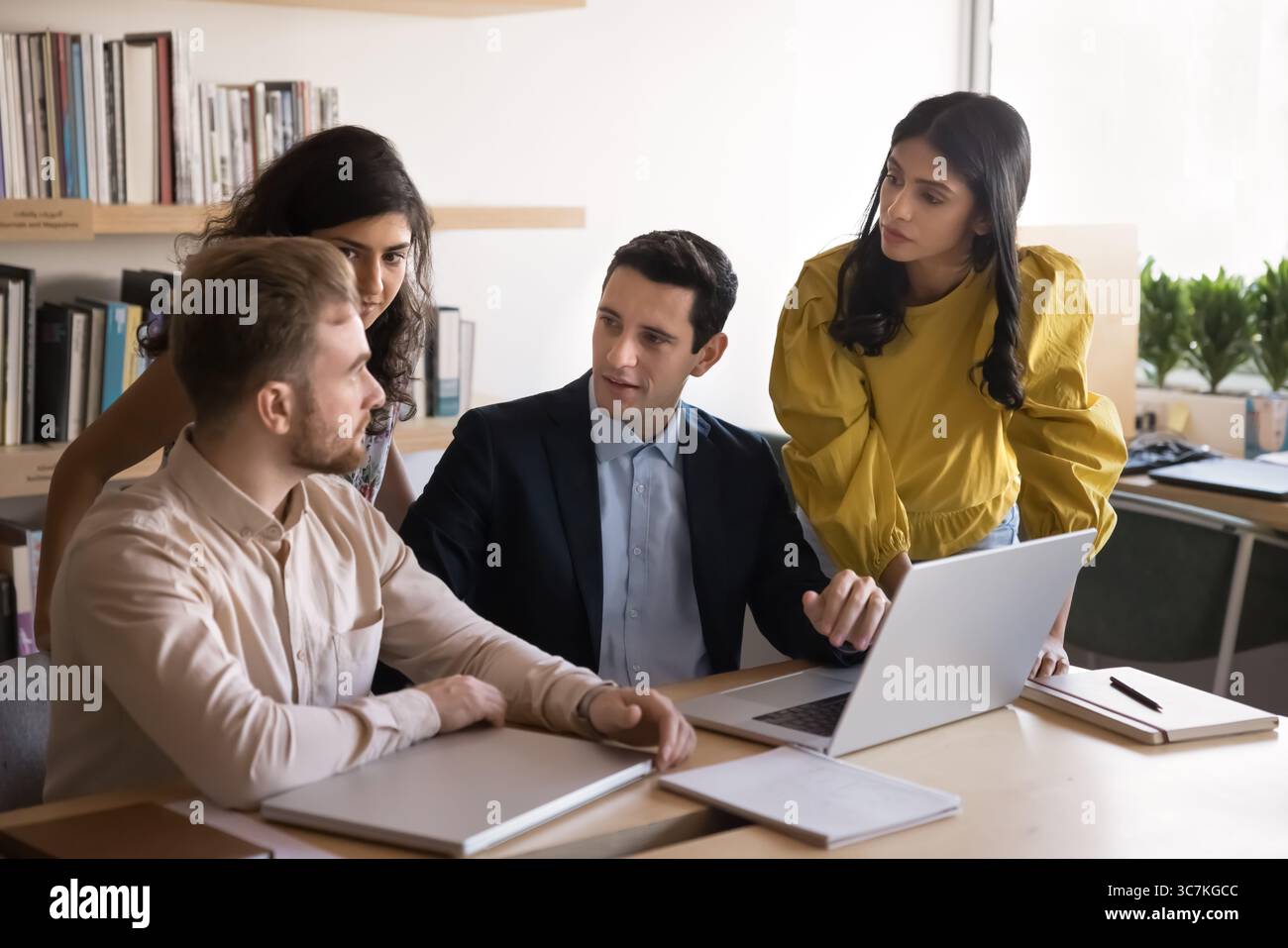 Diverse teammates working on joint online task Stock Photo