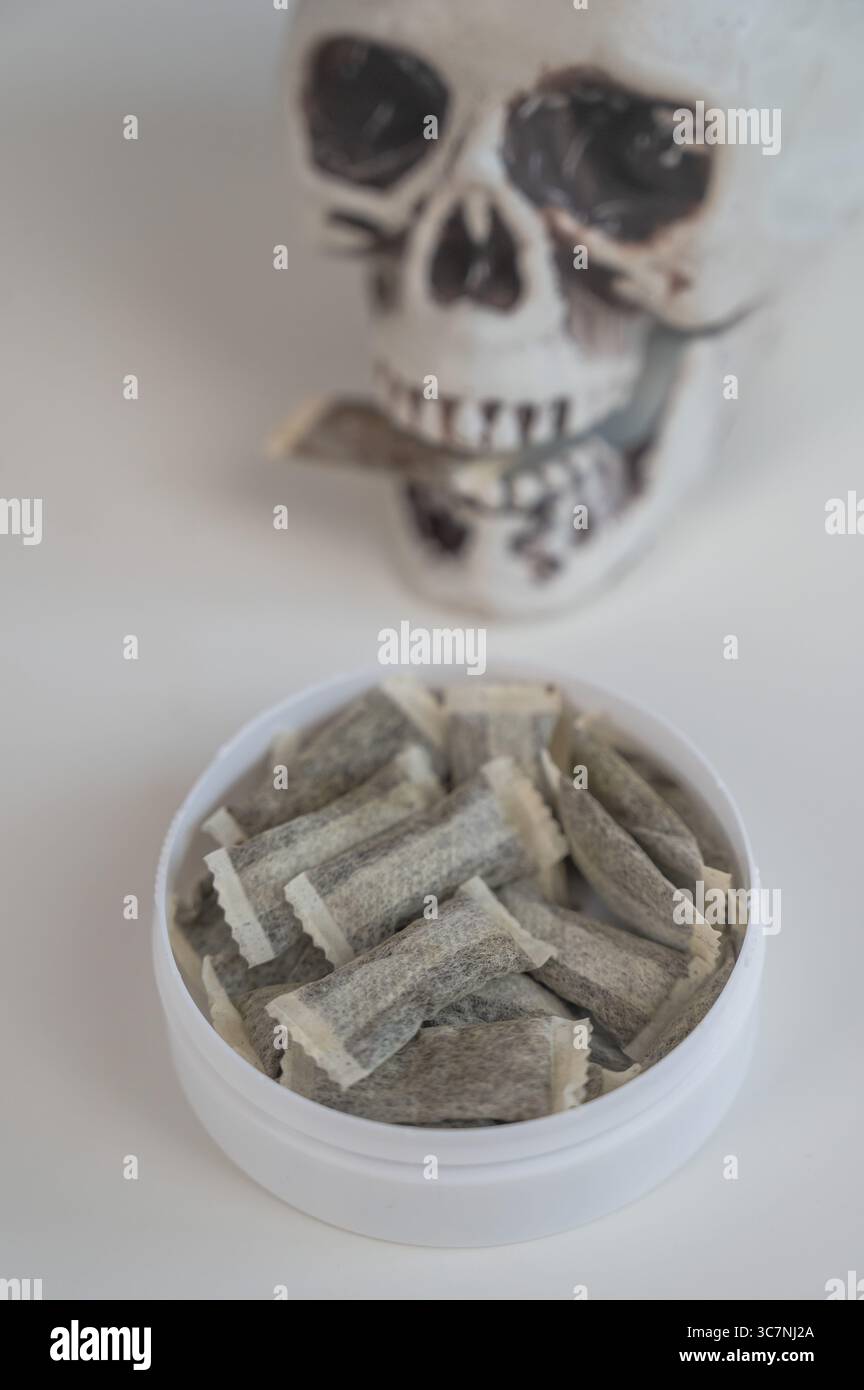 Skull Chewing Tobacco on a White Table Stock Photo