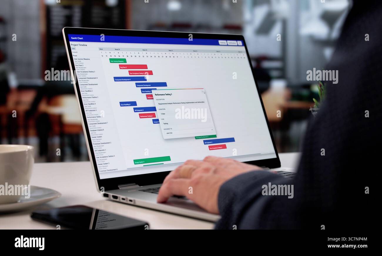 Man In Cafe Using Efficient Schedule Management Software On Laptop Stock Photo