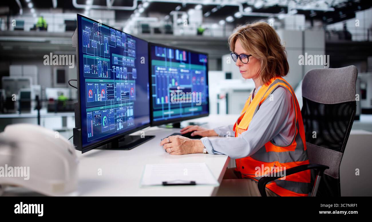 Female Engineer Ensuring Efficiency At Factory Using Computer System Technology Stock Photo